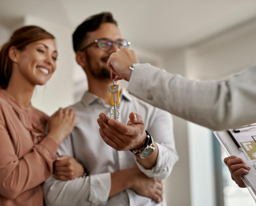 Two people recieving keys to new house