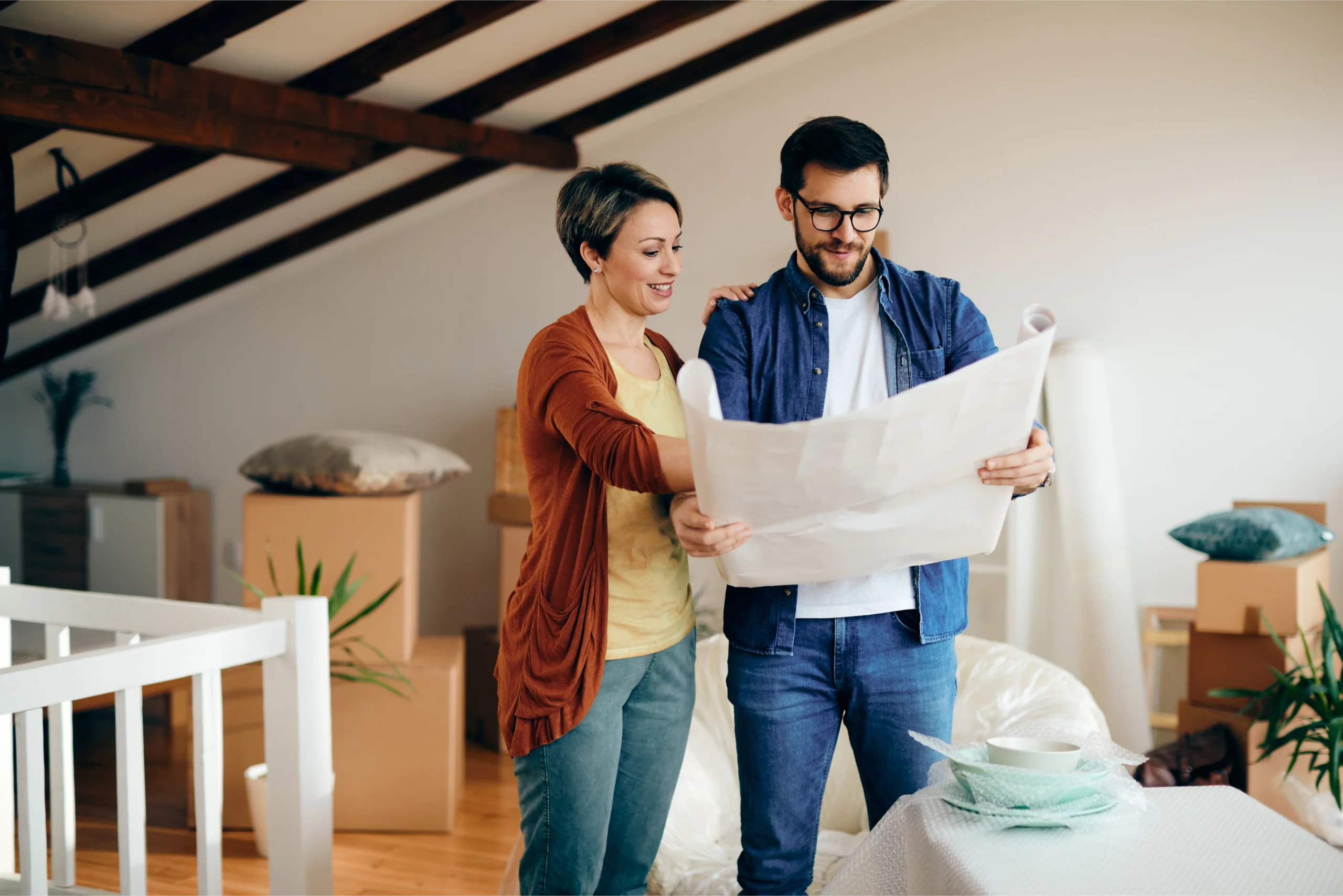 happy couple with house plans